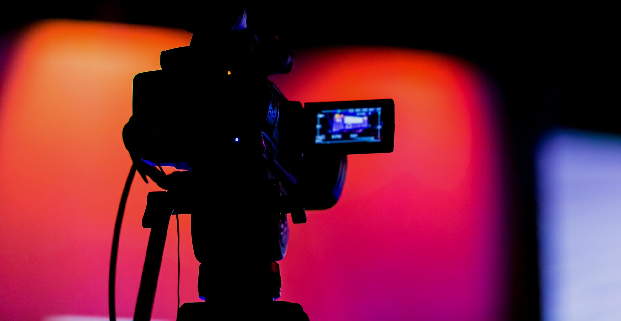 Silhouette of a TV Camera filming a live broadcast